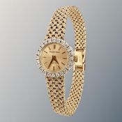 A lady's 9ct gold diamond-set Bueche-Girod wristwatch on 9ct gold integral bracelet