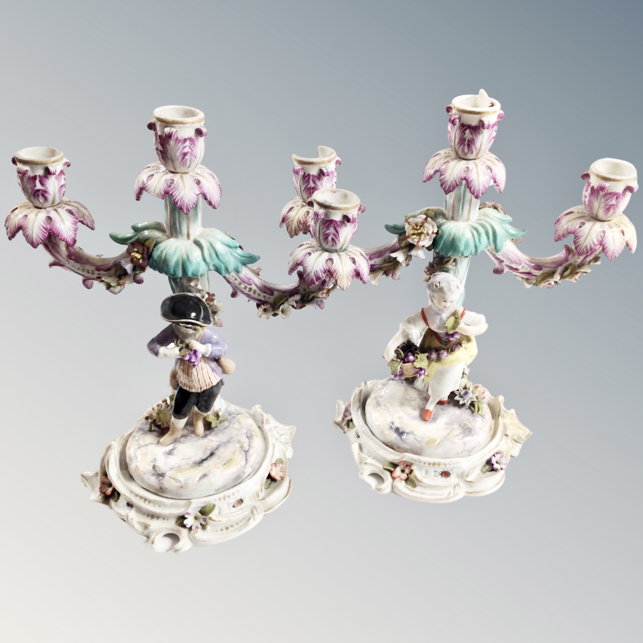 A pair of Meissen style encrusted three branch candelabra,