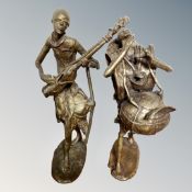 A Benin cast bronze figure - Musician playing a stringed instrument,