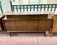 A mid century low sideboard fitted with drawers,