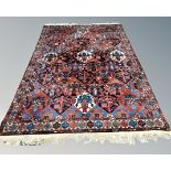 A Bakhtiari carpet, West Iran, with central lattice field of repeating geometric medallions,