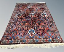 A Bakhtiari carpet, West Iran, with central lattice field of repeating geometric medallions,