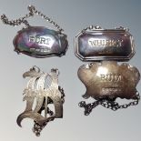 Three various silver decanter labels together with an unmarked brandy label