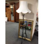 A gilt framed over mantel mirror together with wrought iron standard lamp with shade