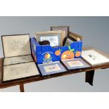 A box of framed pictures,