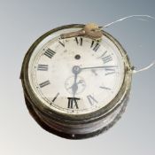 A vintage brass-cased ship's circular timepiece with key