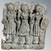 A Benin bronze plaque depicting three servants of the Oba of Benin,