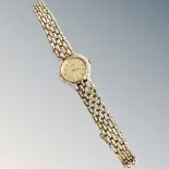 A 14ct yellow gold lady's Roamer wristwatch set with diamond bezel, gross 31.4g.