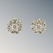 A pair of 14ct yellow gold earrings set with diamonds in floral pattern, 2.3g.