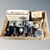 A box of field glasses, assorted clocks,