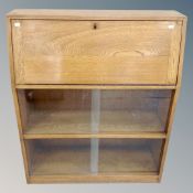 A 20th century oak bureau with bookcase below,