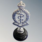 A Royal Army medical corps radiator mascot mounted on plinth