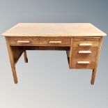 A 1930's oak desk fitted with drawers,