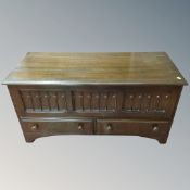 A carved dark oak storage box with two drawers