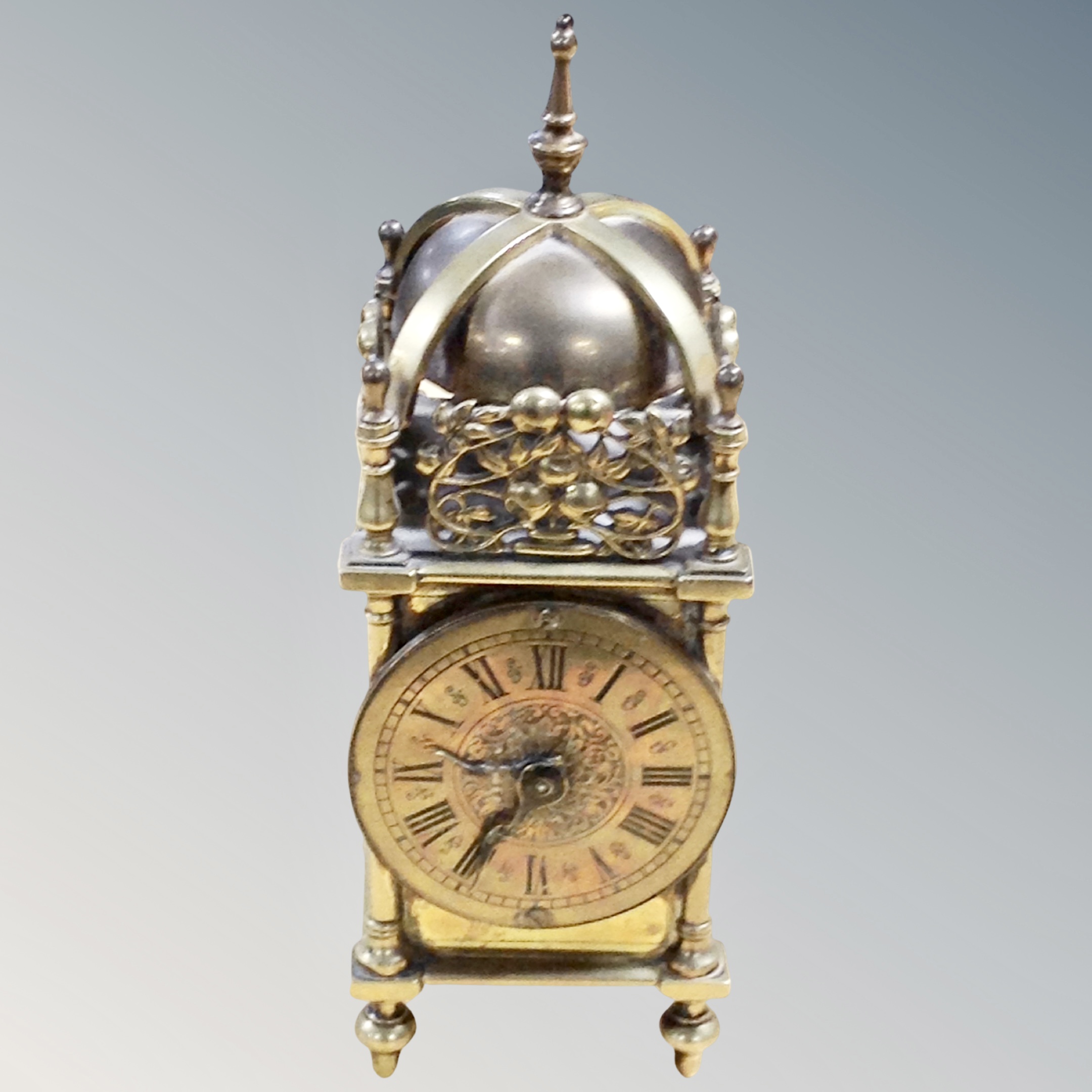 A reproduction brass lantern clock,