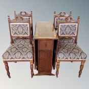 An Edwardian oak drop leaf table and four chairs