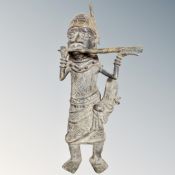 A Benin cast bronze figure - Musician playing a wind instrument,