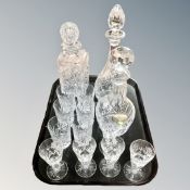 A tray of three heavy cut-glass crystal decanters and assorted glass