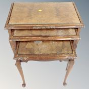 A nest of walnut tables together with an oak gateleg table