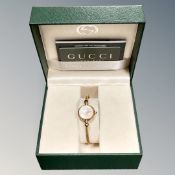 A Gucci lady's wristwatch in retail box with warranty card and booklet