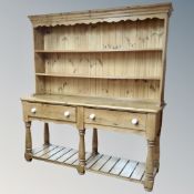 A Victorian style pine kitchen dresser fitted with two drawers,