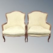 A French style beech framed armchairs upholstered in floral fabric