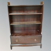A pair of Stag waterfall bookshelves fitted a drawer,