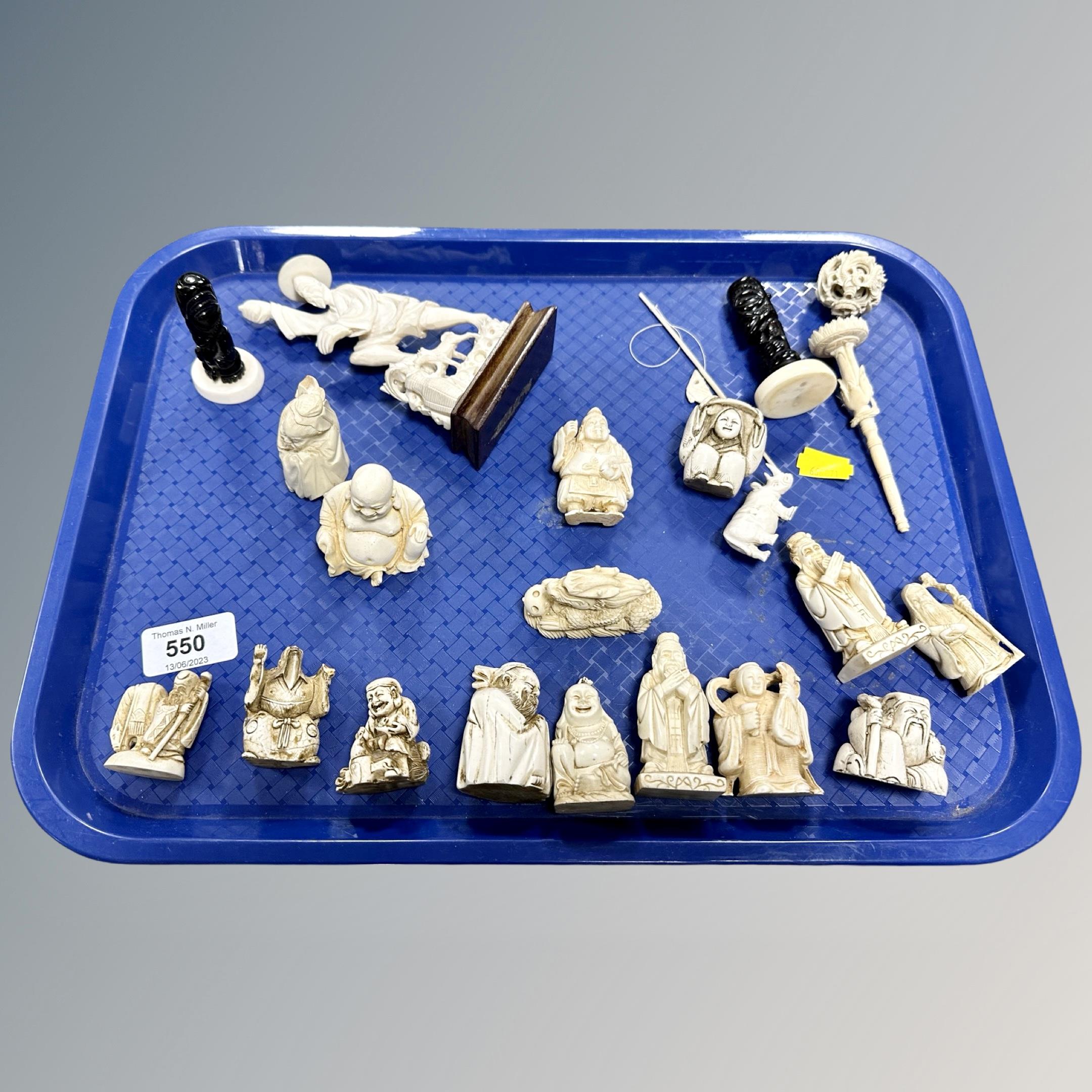 A tray of carved Japanese bone and resin figures and okimonos,