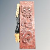 A New Zealand carved wooden Tiki wall hanging with mother of pearl inlaid eyes, length 60 cm,