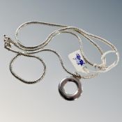 A 22'' sterling silver snake chain with circular pendant also marked 925 in recessed space 29.7g.