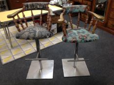 A pair of high chairs on metal bases