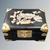 A black lacquered box with mother of pearl decoration and brass reinforced corners