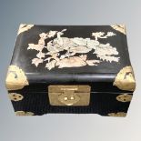 A black lacquered box with mother of pearl decoration and brass reinforced corners