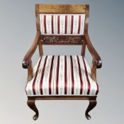 A Continental mahogany armchair in striped fabric