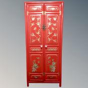 An Oriental style double door cabinet with interior