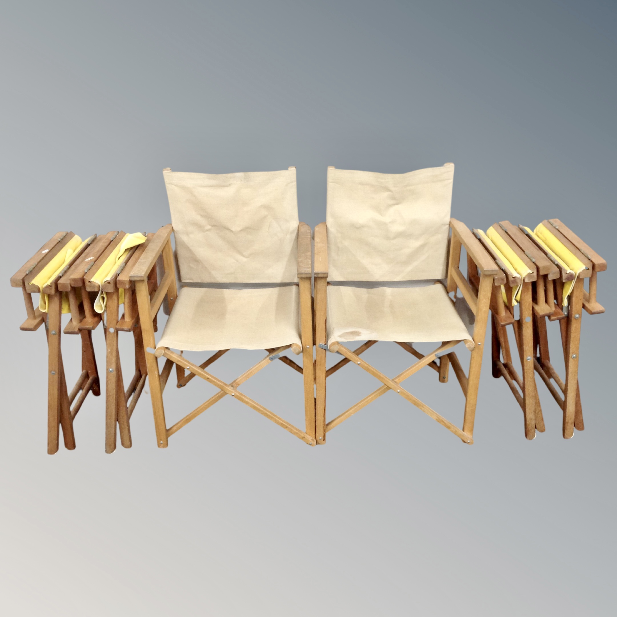 A pair of folding director's chairs together with a further set of four director's chairs.