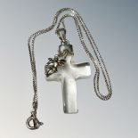 A transparent quartz cross pendant set with silver top and cherub,