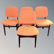 A set of four mid century upholstered dining chairs in orange fabric