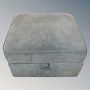 A contemporary fabric upholstered footstool.