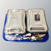 Two silver plated lidded breakfast dishes together with a quantity of various cutlery.