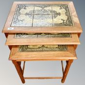 A nest of 20th century tiled topped teak tables CONDITION REPORT: Damage to one