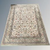 A machine made rug of Persian design,