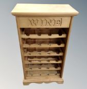 A contemporary pine wine rack