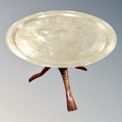 A circular Indian brass table on inlaid folding stand.