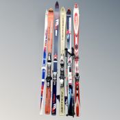 Five sets of skis with bindings to include salomon rossignol atomic etc,