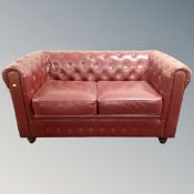 A pair of Burgundy leather Chesterfield style two-seater settees