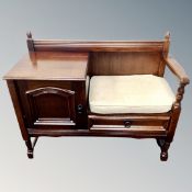 A contemporary oak telephone seat