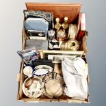 Two boxes containing table linen vintage tins, cased cutlery, brass candle holder etc.