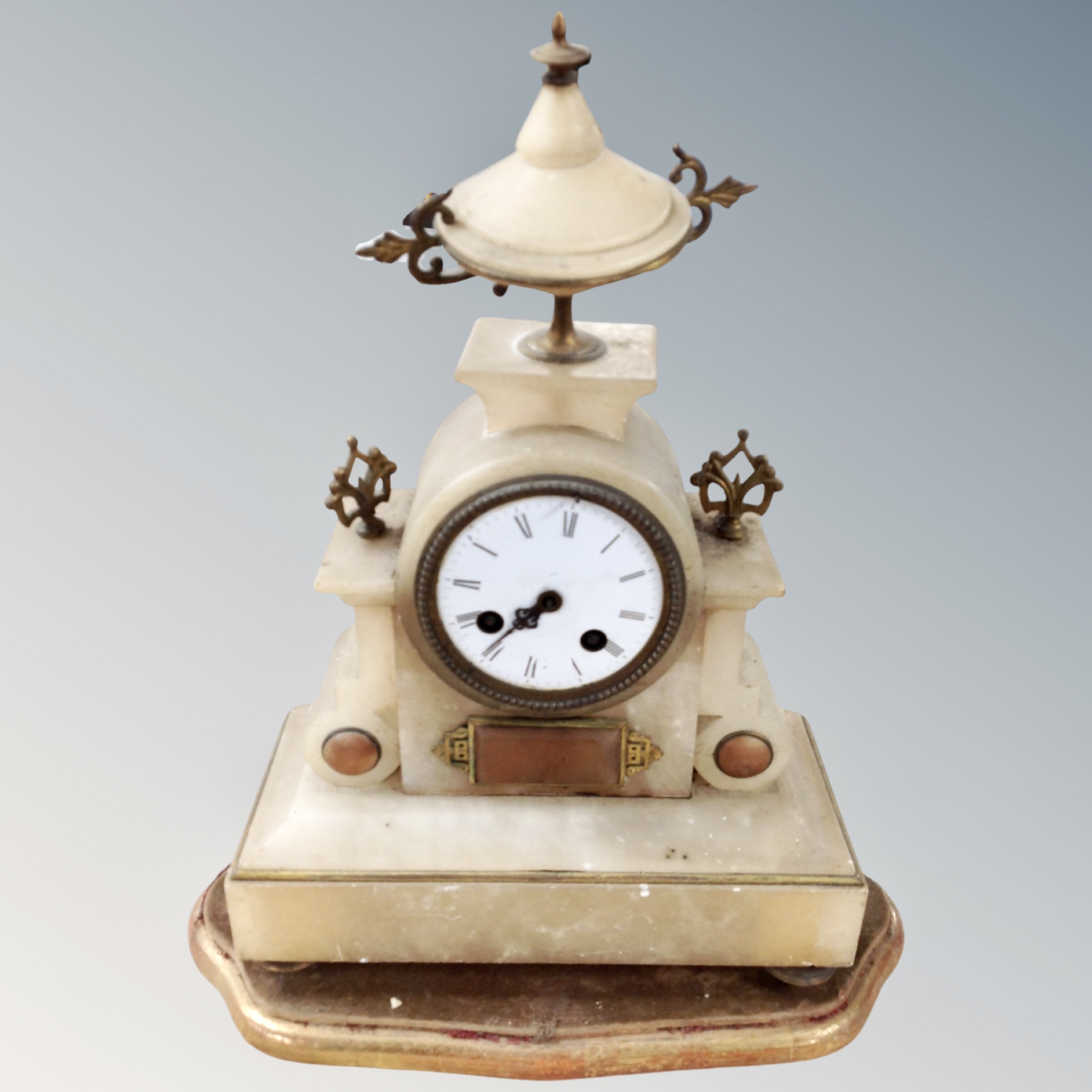 A Victorian gilt alabaster mantel clock on wooden stand