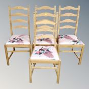 A set of four pine ladder backed chairs